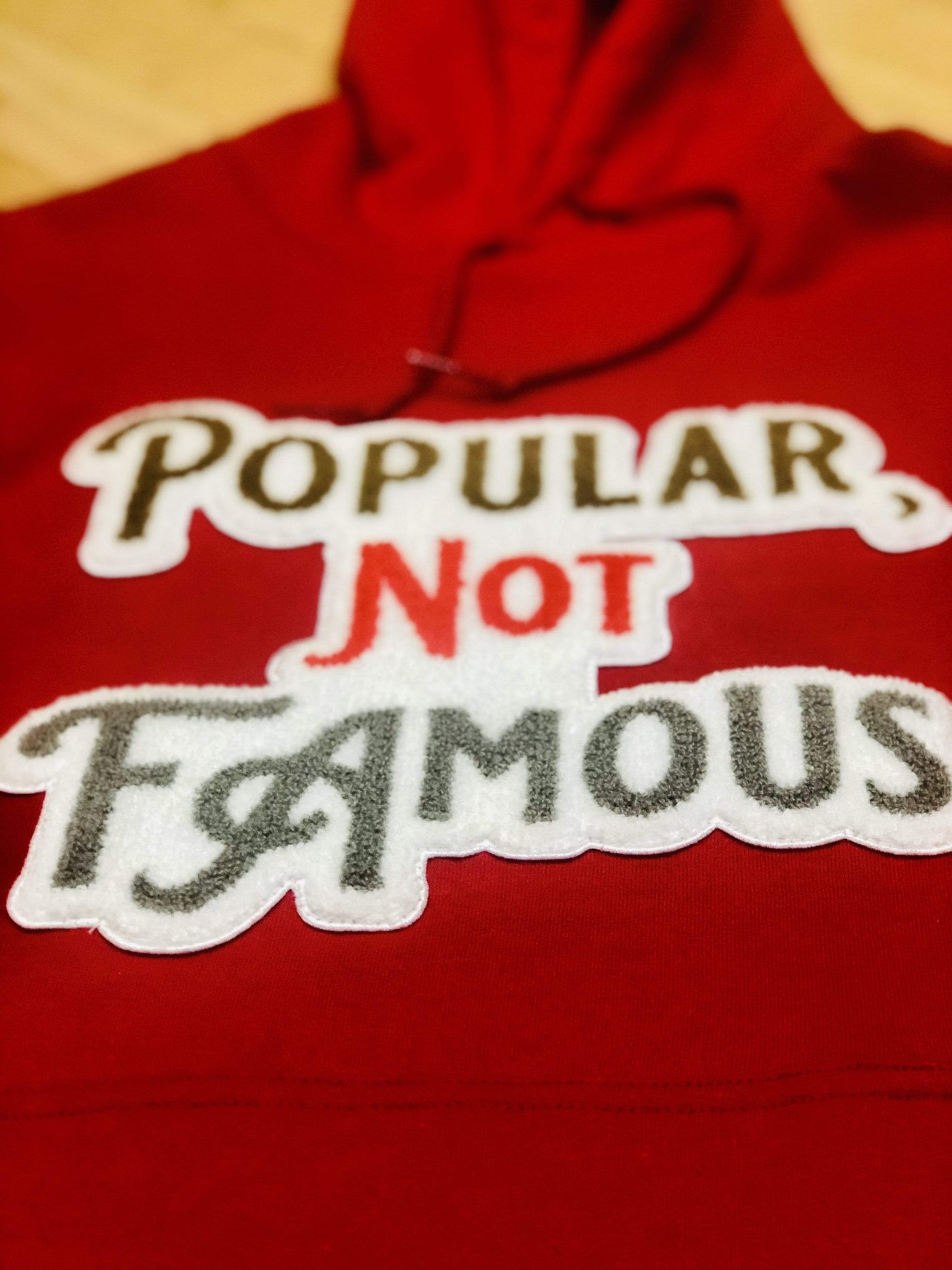 Red Pullover Style Hoodie w/ Chenille Embroidered “Popular Not Famous” Logo